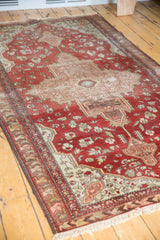 Antique Farahan Sarouk rug section: rich terracotta, ivory, and chestnut medallion with splayed floral field, textural wear.