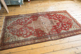 Antique Farahan Sarouk rug corner, rich terra cotta and ivory field with splayed floral geometric motifs, consistent wear.