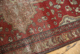 Farahan Sarouk rug detail: terra cotta field with geometric floral motifs, and historic wear.