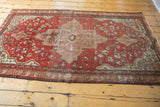 Antique Farahan Sarouk rug's lower section; geometric border, splayed floral field, and time-softened tones.