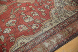 Antique Farahan Sarouk rug with time-softened terra cotta and ivory geometric patterns.