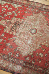 Antique Farahan Sarouk rug showcasing terra cotta field, splayed floral motifs, and low pile texture.