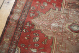 Antique Farahan Sarouk rug with terra cotta field, geometric floral motifs, and visible even pile wear.