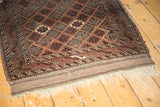 Fringed end of antique Belouch rug, intact plain weave and geometric lattice.