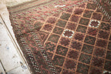Plain weave end, etched pile, and geometric patterns of an antique Belouch rug.