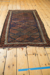 Frayed ends and original plain weave on the antique Belouch rug.