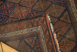 Storied goat hair side selvage and intricate pawn design border of an antique Belouch rug.