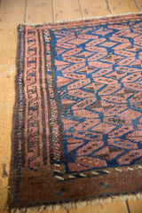 Hand knotted Persian Belouch rug's geometric border with chestnut and navy gul motifs.