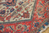 Antique Malayer runner corner with red border, patterned beige field, and visible tattered edge.