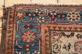 Kurdish Malayer rug corner detail with sky blue field, blush red border, worn fringe.