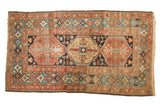 Antique Heriz rug: triple medallion, allover floral-animal field, rare celadon green border.