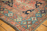 Antique Heriz rug corner featuring a rare celadon green border and floral starburst motifs.