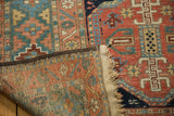 Hand-knotted Heriz rug back, original dark selvage, beige fringe, and low pile.