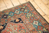 Corner detail of antique Heriz rug; rare green border, vibrant motifs, low pile, visible knot heads.