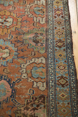 Distressed Lilihan rug showing worn floral palmettes, chestnut brown, sky blue, and geometric border.