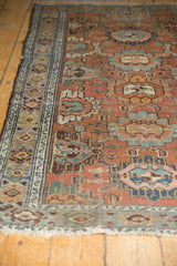 Distressed Lilihan rug with worn chestnut field, sky blue, gold, and ivory floral patterns.