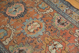 Distressed Lilihan rug's worn floral palmettes in sky blue, ivory, and rich brown hues.