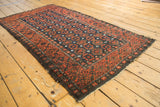 Antique Belouch rug end, displaying tatter and dark goat hair selvage.