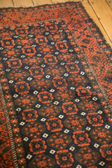 Belouch runner's field with brick red, charcoal, ivory motifs and starburst border.