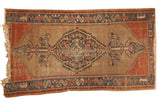 Antique Malayer rug: dramatic central medallion, cypress finials, camel field, madder red and blue borders.