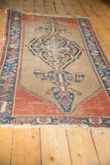 Antique Malayer rug's dramatic central medallion, cypress finials, and camel ground showing even wear.