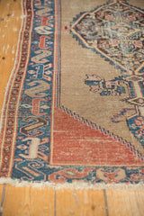 Antique Malayer rug corner with camel field, stepped madder root red border, and blue cloud-band motif.