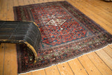 Antique Fereghan rug's madder red Herati motif field with visible etching to celadon greens.