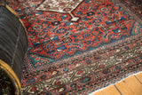 Antique Fereghan rug detail: madder red field, Herati motif, geometric borders, time-softened greens.