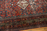 Antique Fereghan rug corner with intricate borders, Herati field, and time-softened celadon green.