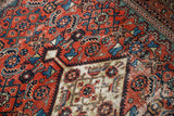 Herati motif in madder red and etched celadon green on an antique Fereghan rug.