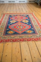 Antique Caucasian rug's unusual red geometric border and tattered fringe.