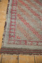 Heavily etched pile, exposed foundation, and worn selvage of an antique Belouch rug runner.