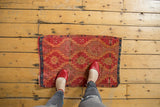 Geometric medallions and etched low pile texture on an antique Turkish Yastik rug.