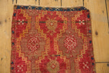 Repeating geometric medallions and hatched channels detail on the antique Turkish Yastik rug in ruby red and saffron.