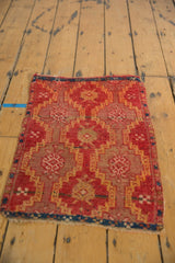 Antique Yastik rug corner displays geometric medallions, hatched channels, and etched ruby red pile.