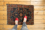 Vintage Mohajeran Sarouk rug with diminutive medallion, bursting floral vines on navy.