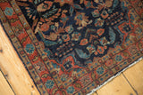 Vintage Mohajeran Sarouk corner detail, showing navy field, brick red border, and low pile wear.