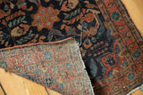 Hand-knotted Mohajeran Sarouk rug back weave, tattered end, and navy floral pile detail.