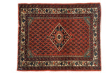 Vintage Persian Engelas mat with a diamond medallion on a red boteh field and a playful, colorful border.