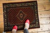 Vintage Engelas rug showing its brick red boteh field, diamond medallion, and colorful border.