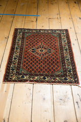 Angled perspective of the vintage Engelas rug's boteh field and central medallion.