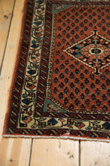 Charismatic colorful border and brick-red boteh field on a vintage Persian Engelas rug mat corner.