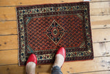 Vintage Persian Engelas rug mat with a diamond medallion and boteh field, viewed from above for scale.