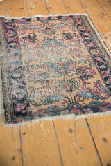 Tattered fringe and worn border of antique Lilihan rug, revealing knot heads and floral design.