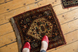 Antique Afshar rug detail features navy, ivory, and wine red geometric pinwheel motifs.