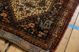 Intricate stylized bird and floral motifs on a hand-knotted antique Afshar rug border.