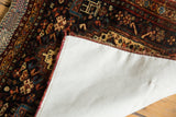 Linen-covered reverse of antique hand-knotted Afshar rug with secured fabric tape, rich tribal motifs.