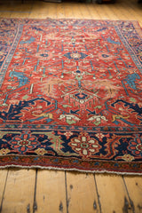 Antique Heriz carpet border showcasing navy blue ground, geometric motifs, and fringed end.
