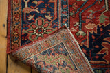 Hand knotted foundation and detailed geometric patterns on this antique Heriz carpet.