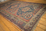 Antique Soumac carpet's intricate field motifs and geometric-floral border in brick red and navy.